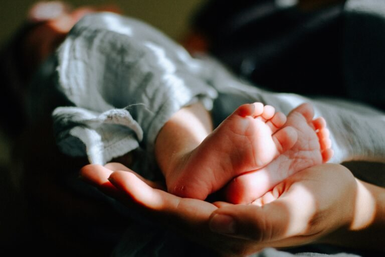 person-holding-baby-feet
